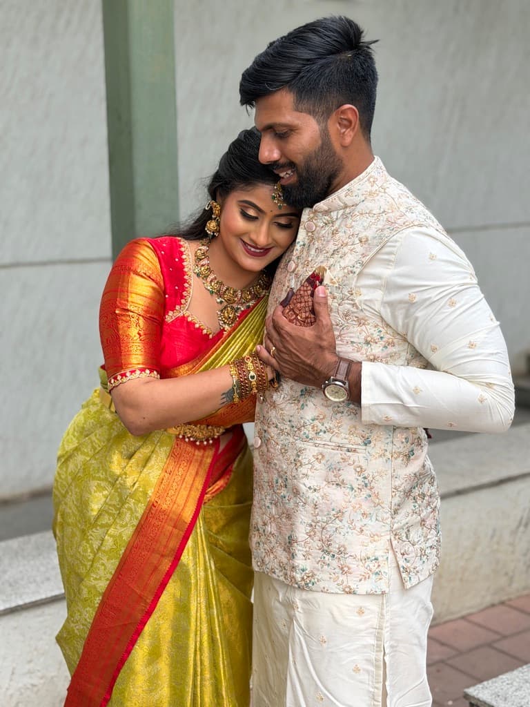 Rakshitha resting her head on Yathish’s shoulder, smiling